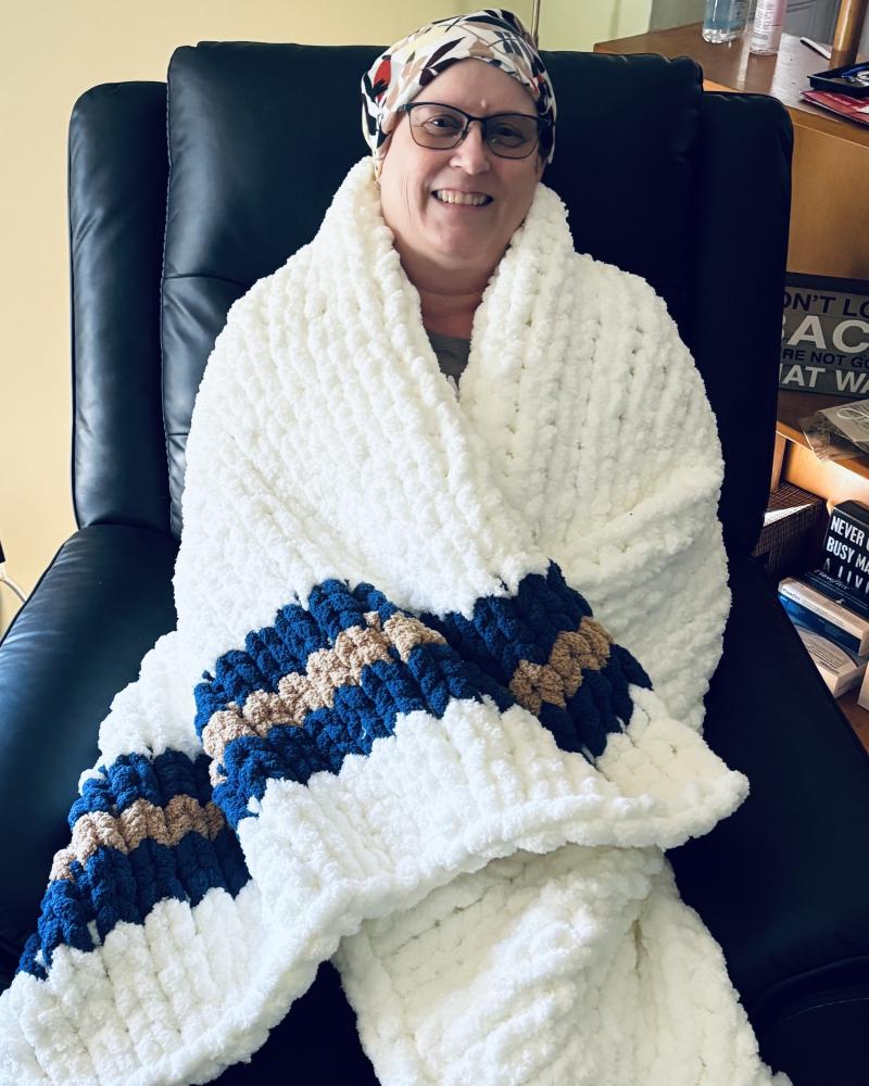 Client wrapped in a Never Alone blanket